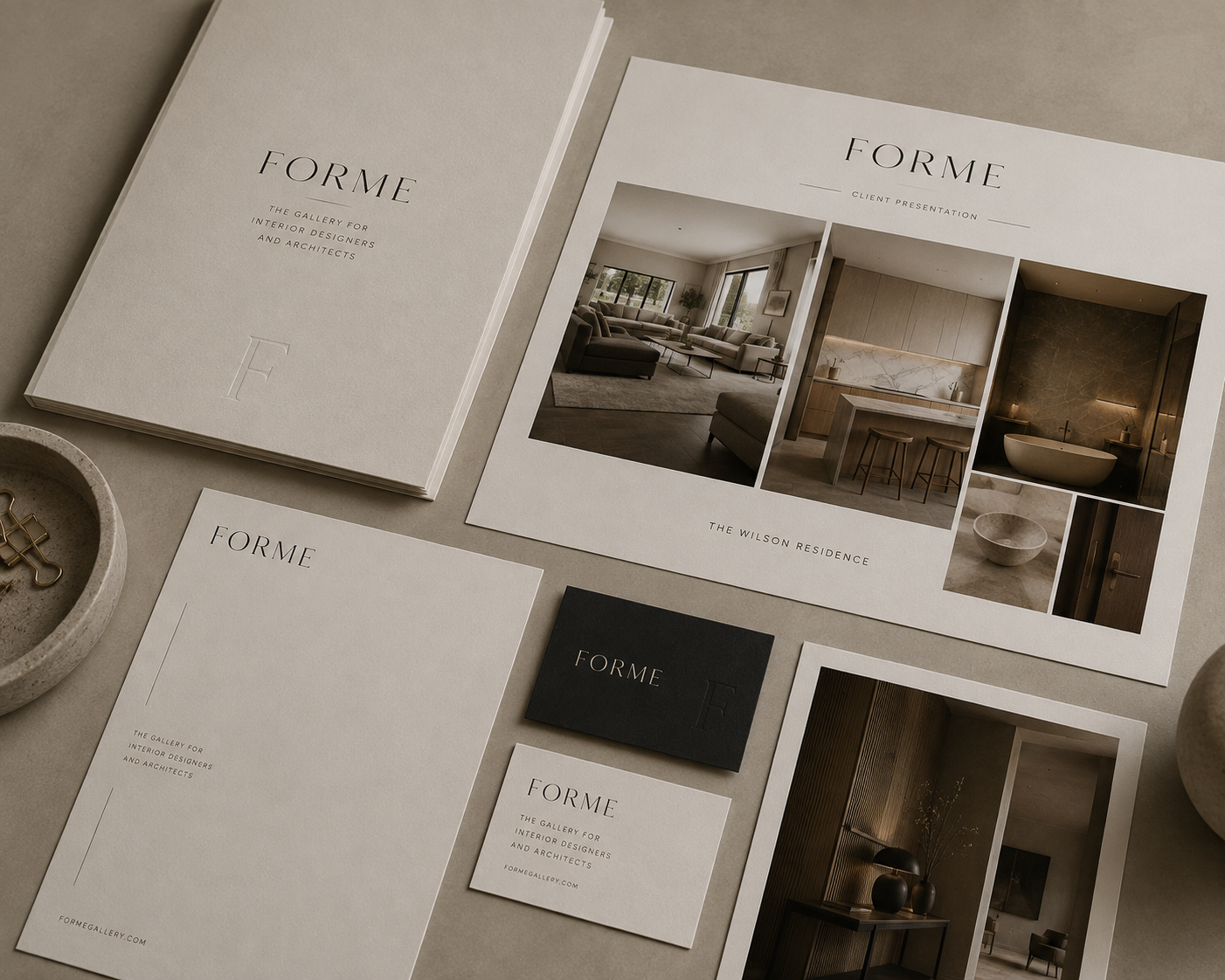 Printed FORME folios, client cards and material samples arranged on stone
